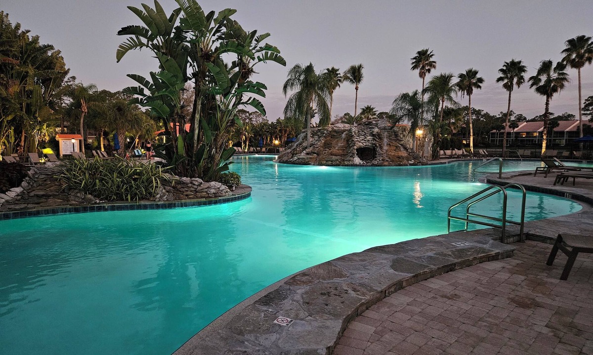 Naples Condo | Relax on the oversized lanai featuring an outdoor kitchen and mid-water view.