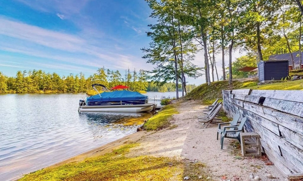 Pine River Pond House | Stunning lakefront home with private dock, deck, firepit, and lake view