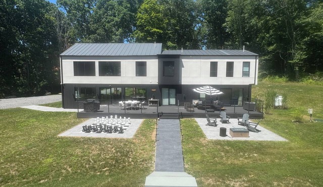 Experience elevated living in a magnificent brand new modern home set on 5 acres in Clinton Corners