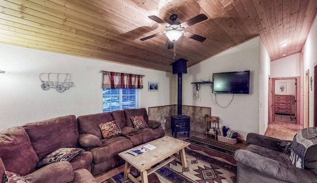 Waterfront cabin with mountain view, wood stove, private hot tub, & WiFi
